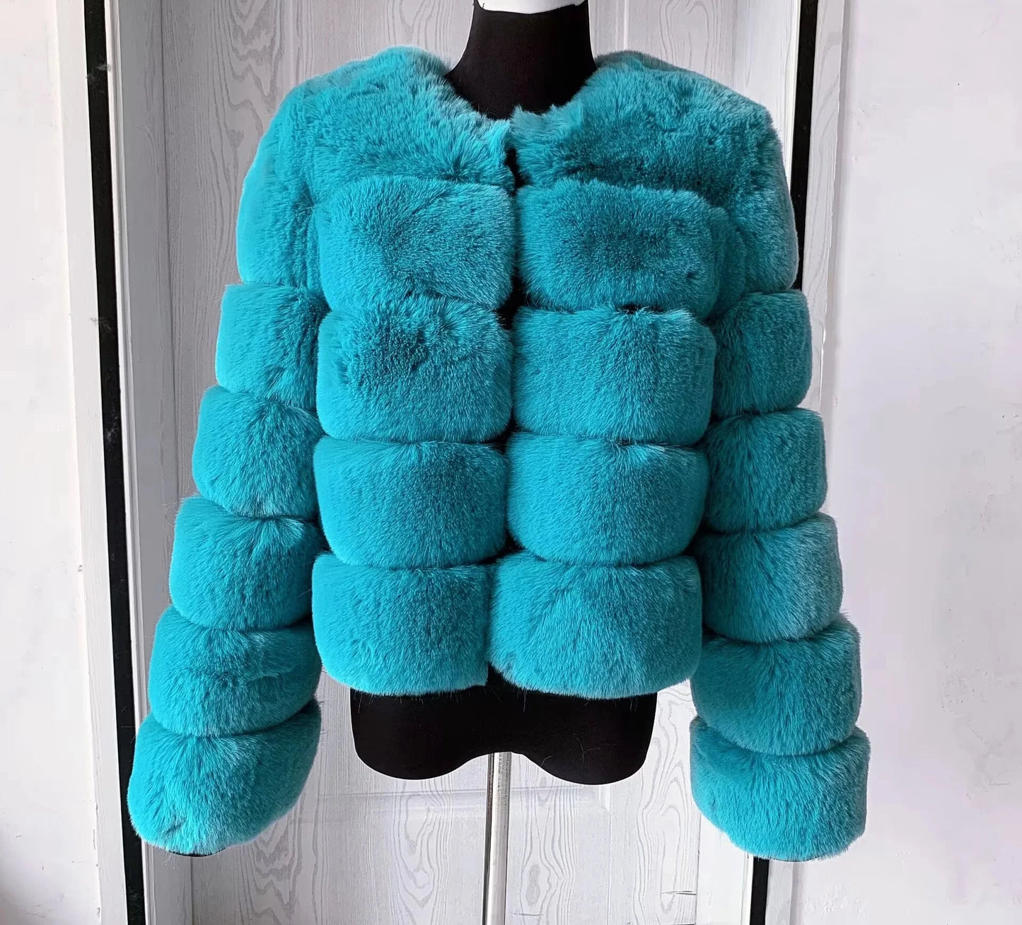 "Amoura Elegance women’s faux fur coat in vibrant turquoise, designed for a chic autumn and winter look. This high-quality 60 cm jacket features luxurious, fluffy faux fox fur with full sleeves, offering both warmth and style. Available in size XXXXL, it’s crafted to add elegance and comfort to any wardrobe."