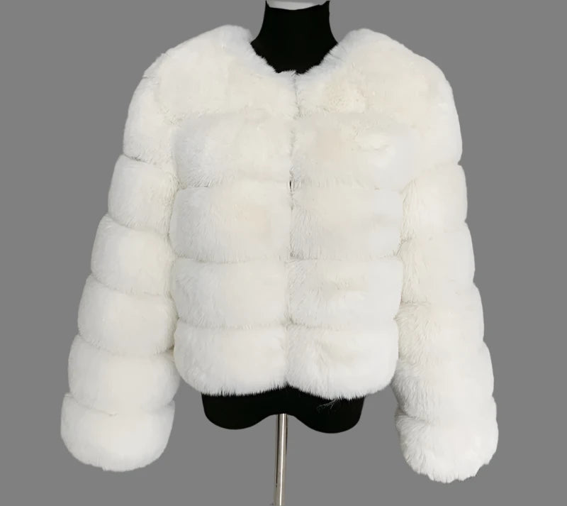 "Amoura Elegance women's full faux fur coat in pure white, designed for a sophisticated look in autumn and winter. This high-quality, 60 cm jacket showcases fluffy faux fox fur with full-length sleeves, offering a balance of warmth and style. Available up to size 7XL, it provides a luxurious, comfortable fit perfect for cooler seasons."