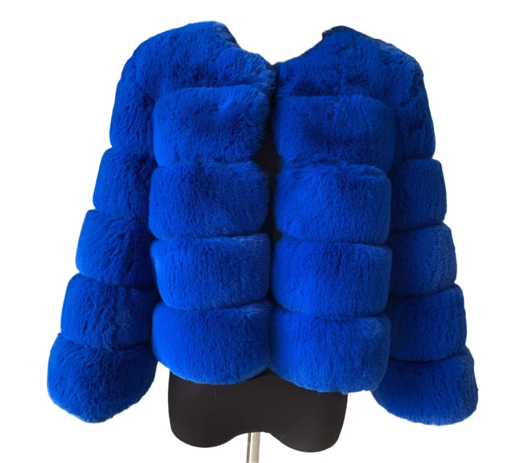 "Step out in style with the Amoura Elegance women's short faux fur coat in a captivating blue shade, perfect for the autumn and winter seasons. This luxurious 50 cm jacket is crafted from high-quality faux fox fur and features trendy short sleeves, offering a chic yet cozy look. Available up to size 7XL, this coat combines comfort and sophistication, making it a must-have addition to any fashion-forward wardrobe."