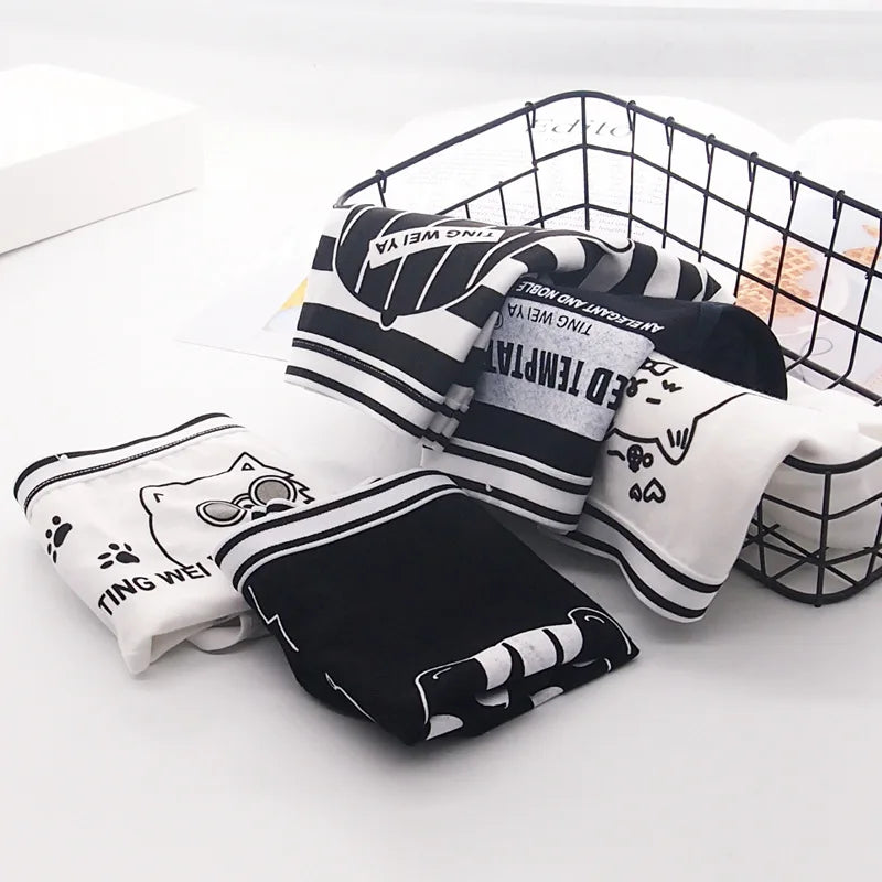 "Pack of 5 black and white women’s knickers featuring a fun cartoon cat design, in a soft, comfortable material."