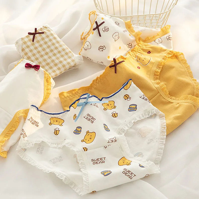Set of yellow and white ladies' panties with playful prints, combining comfort and style in Amoura Elegance’s affordable lingerie collection