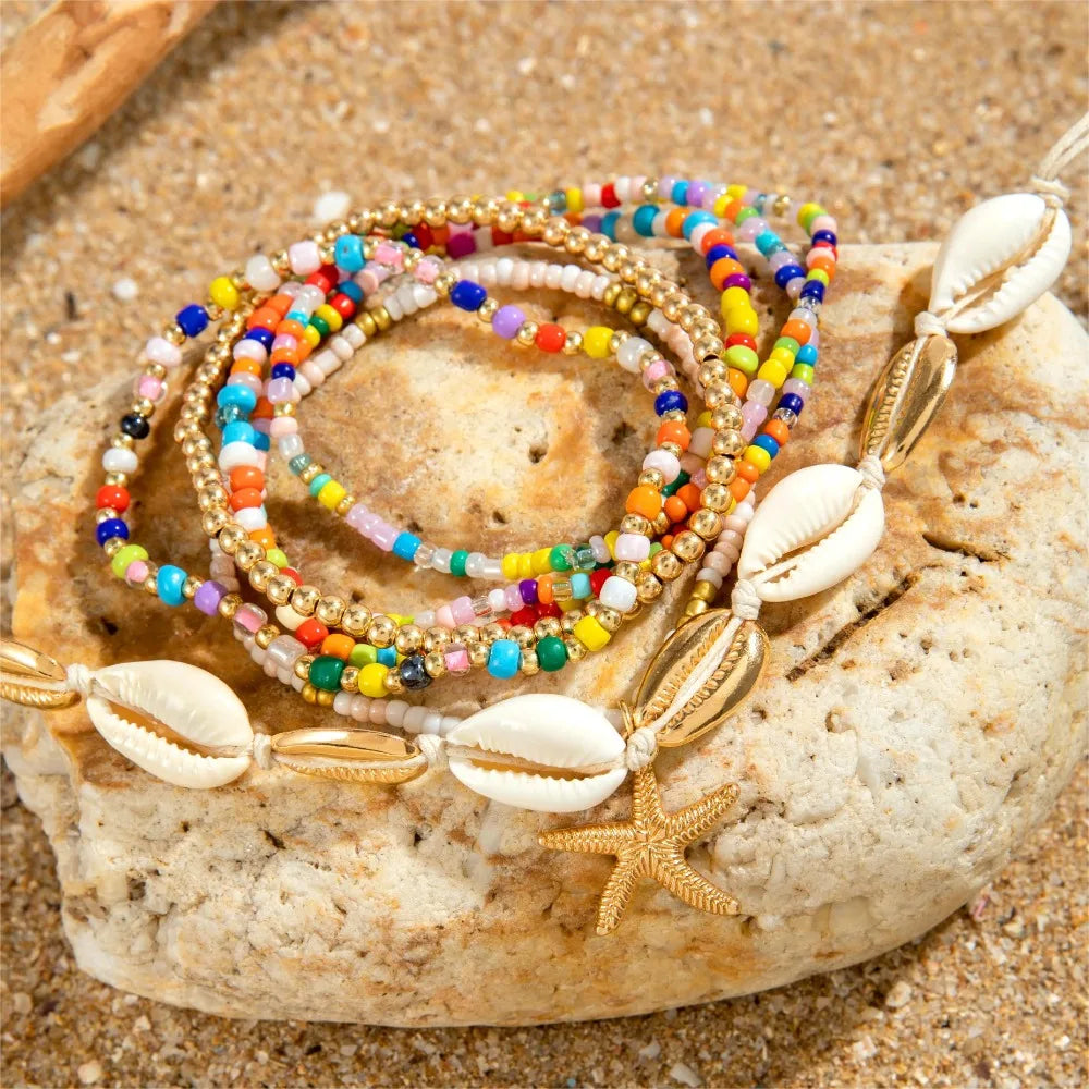 "AmouraElegance 7Pcs Bohemian Beach Rice Beads Elastic Anklet Set | Charm Alloy Anklets with Stretch Holiday Starfish & Multi-layer Design"